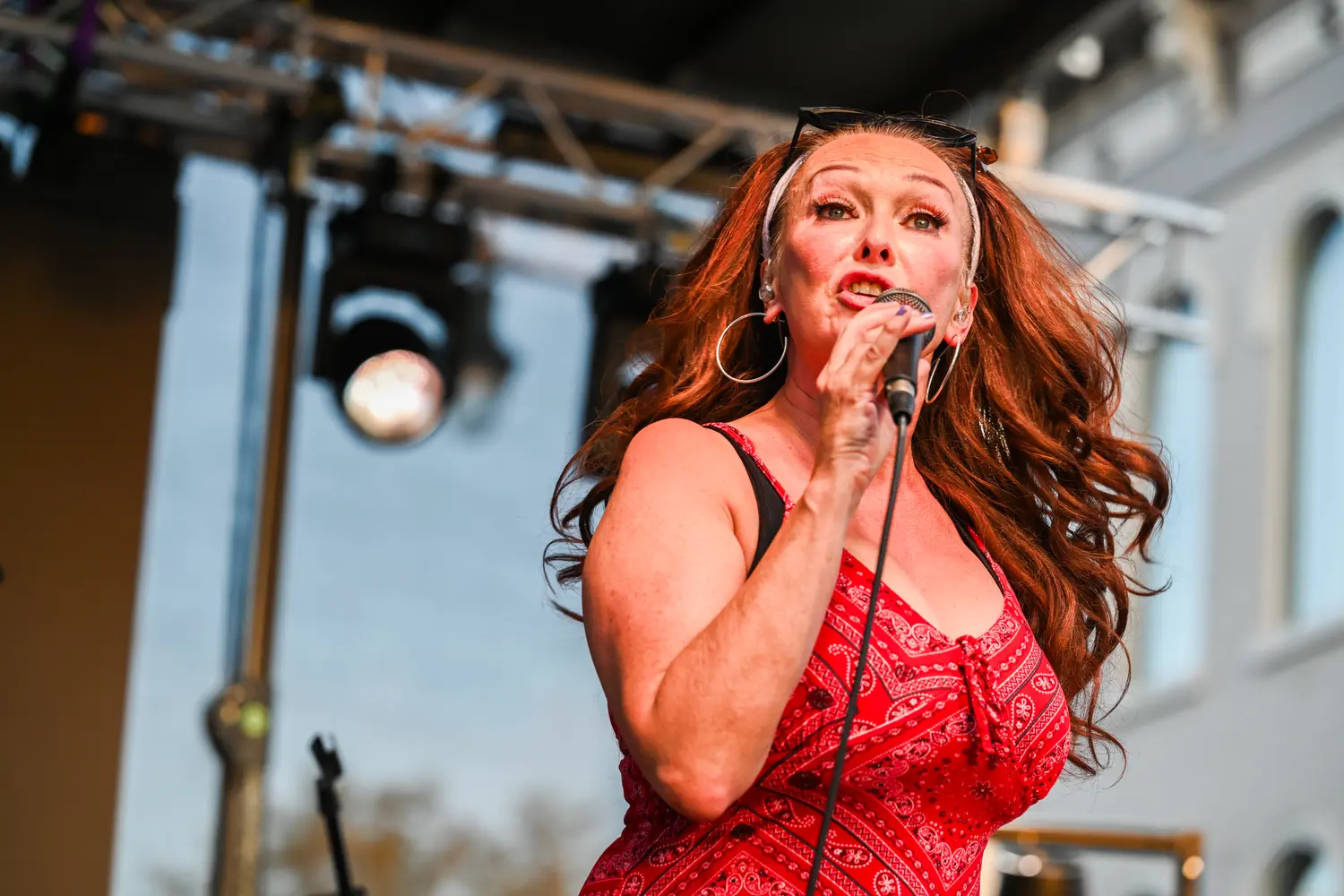 A singer performing on an outdoor stage