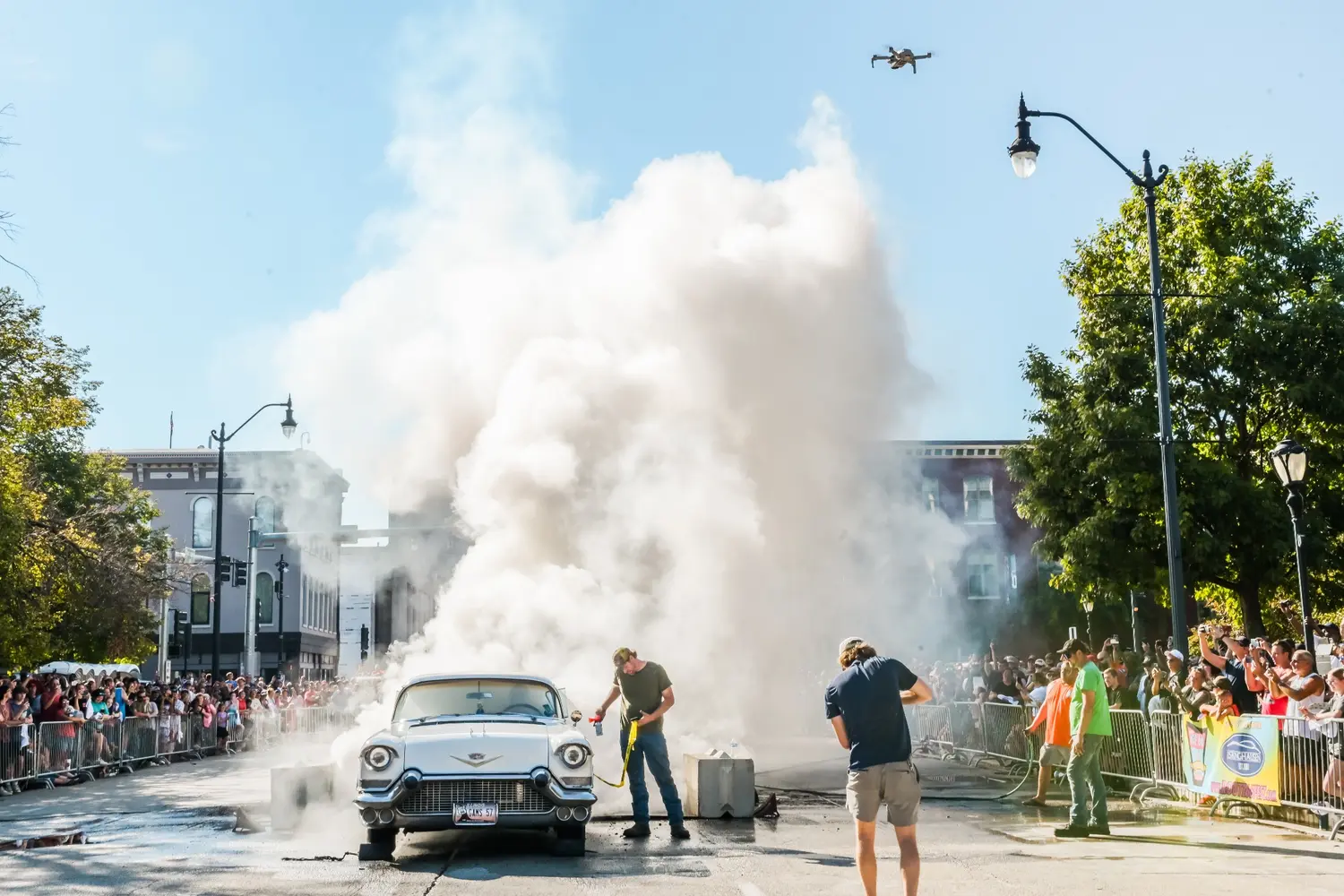 A classic car creating smoke during a Route 66 event