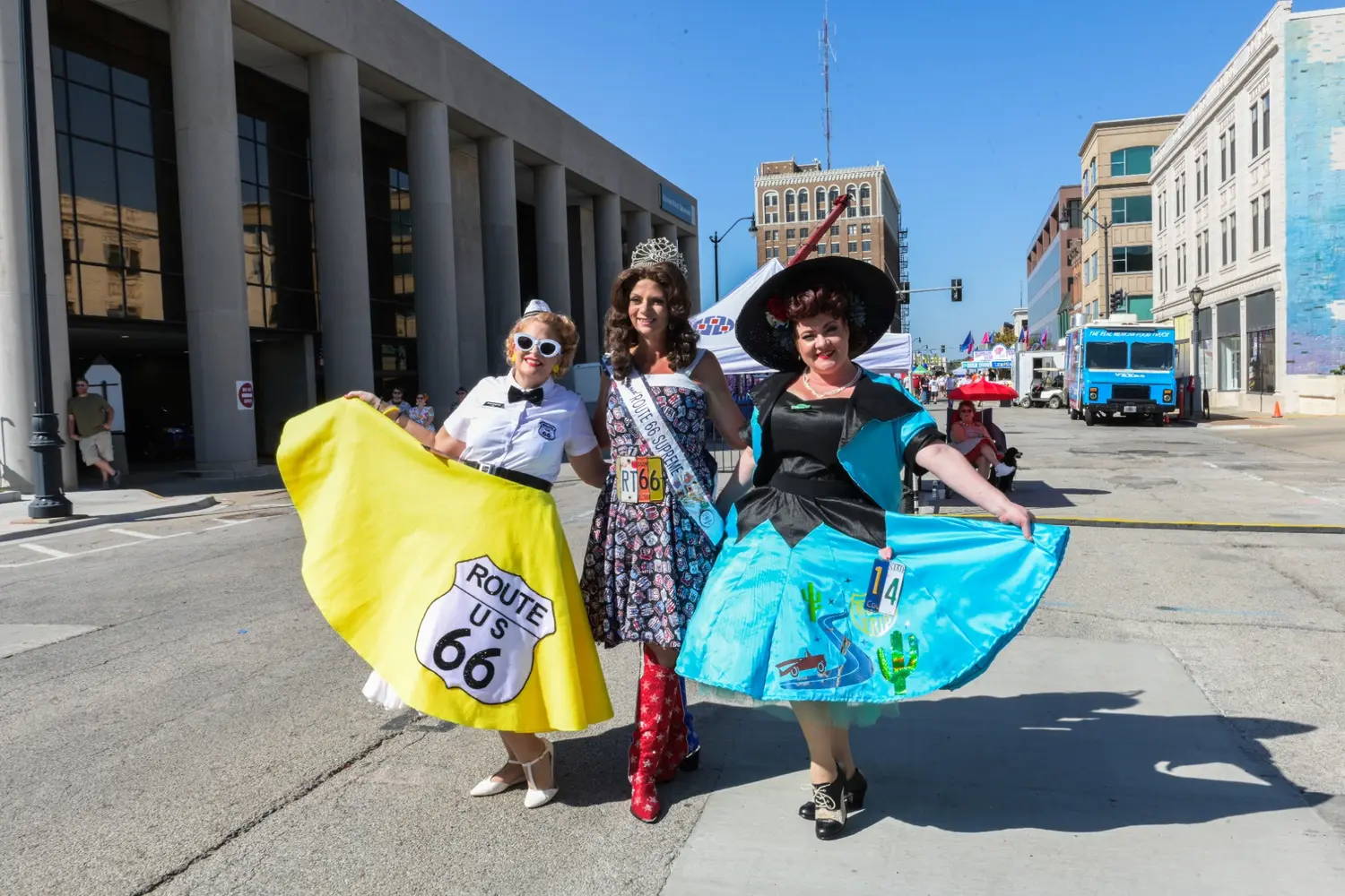 Three people wearing colorful Route 66 event outfits